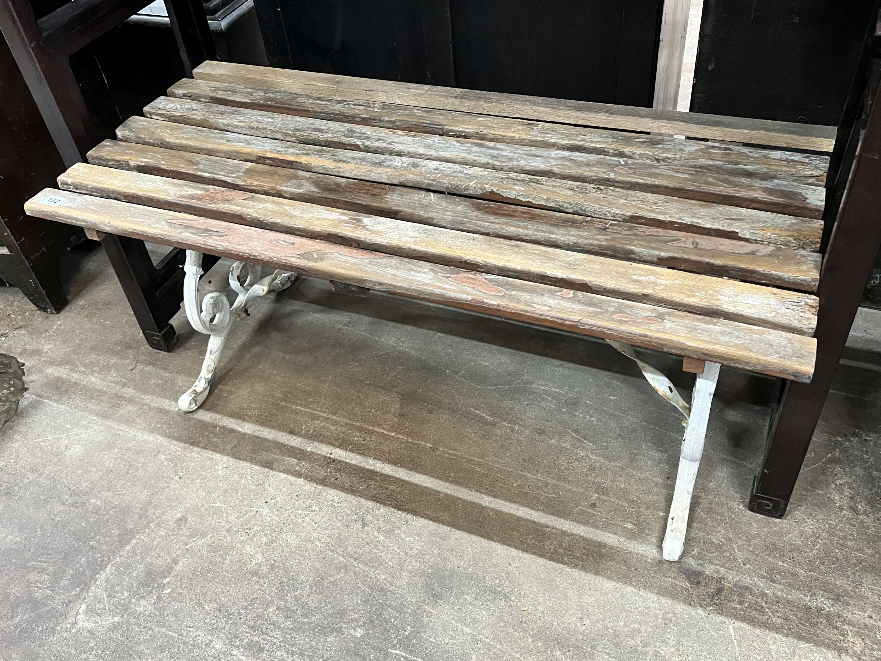 A painted aluminium garden seat, length 110cm, together with a similar smaller seat